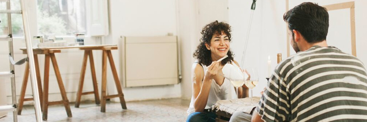 Man and women enjoying wine during DIY project